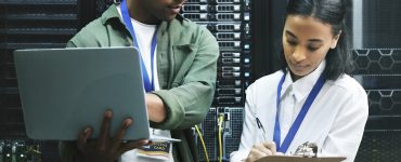 Two Gen Z workers in a server room