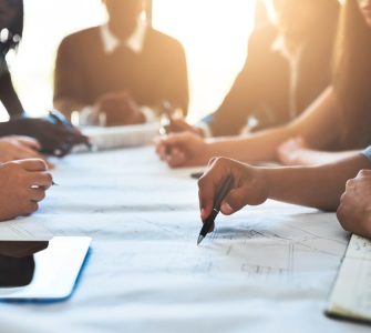 people collaborating about recruiting tools on a big table