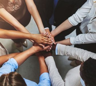 Group of people in a circle with hands together