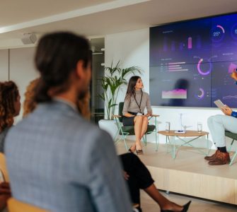 people in a conference room looking at recruitment statistics as they plan for 2025